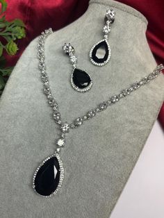 Gorgeous fine quality imitation jewellery  CZ black with CZ diamonds studded necklace with white gold rhodium plating and matching Earrings Item contains: Necklace and earrings AAA quality cubic zirconia used. Highest quality and craftsmanship Necklace Fitting is adjustable Earrings Closure: Pushback Necklace Closure: chain with Hook Details-  -Handmade item -Delivery from a small business in India -Materials: white rhodium, stones, cz, zircon, American diamond -Jewellery type: Earrings, Necklace -Style: Art deco *CARE INSTRUCTION* You can use Jewelry for years together with the help of below jewelry care instructions. * Protect from sharp blows/scratches and extreme temperature. * Avoid contact with perfumes, sprays, chemicals and water. * Keep in a clean, dry and airtight Zip-pouch. * Wi Luxury Black Spinel Necklaces For Formal Occasions, Black Diamond Jewelry For Gift, Black Diamond Jewelry For Gifts, Black Diamond Jewelry Gift, Black Fine Jewelry Necklaces For Wedding, Elegant Diamond Jewelry Sets With Stones, Black Fine Jewelry Necklace For Wedding, Silver Jewelry Sets With Diamond Accents For Party, Diamond White Jewelry Set With Rhinestones For Gift