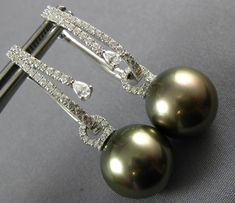 18KT WHITE GOLD HANGING EARRINGS. 3D TEAR DROP DESIGN. DIAMONDS ARE F/G COLOR, VS CLARITY .79 CARATS. FEATURES AAA TAHITIAN PEARL. MEASURES 38mm X 14mm. WRITTEN APPRAISAL AVAILABLE. COMES IN A PRESENTABLE GIFT BOX. SERIOUS OFFERS CONSIDERED #AA-E012546-T Gold Hanging Earrings, Beautiful Pearl Necklace, Drop Design, Hanging Earrings, Sea Pearls, Tahitian Pearls, Solitaire Pendant, Drops Design, Classic Ring