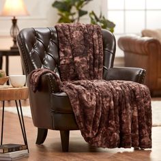 a chair with a blanket on it in a living room