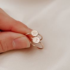 The latest offering in our birth flowers collection is the dainty birth flower disc ring. Holding a meaningful birth flower, each ring is sized to fit and made from scratch with the utmost love and care. Each mini birth flower, hand stamped on a tiny disc and set on a round ring band Available in sizes 2 US to 15 US Need help with sizing? Look at our size guide or purchase our ring sizer Due to its handmade nature, there may be some colour variances where the solder seam is Each Stamp + Shine pi Dainty Birth Flower Promise Ring, Dainty Personalized Flower Ring, Dainty Nickel-free Flower Ring, Dainty Sterling Silver Birth Flower Ring, Dainty Birth Flower Ring, Minimalist Birth Flower Ring, Personalized Dainty Flower Ring, Minimalist Adjustable Flower Ring With Birth Flower, Minimalist Adjustable Birth Flower Ring