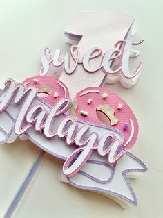 there is a sign that says sweet managa and donuts on top of it