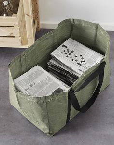 a bag filled with newspapers sitting on top of a floor