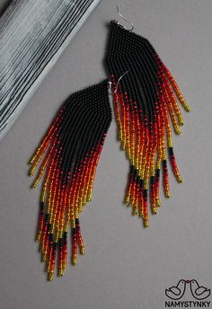 These fire red beaded earrings are made of high-quality Czech beads and strong synthetic thread. They are elegant, fashionable, and highly versatile, suitable for everyday wear. Features: Sterling silver components Color: black, red, yellow. This item is currently in stock. You must be completely satisfied. If you find merchandise unsatisfactory for any reason, return it within 10 days and your money will be refunded without questions. More beaded earrings http://etsy.me/2ycItdb Gerdan necklaces Red Beaded Fringe Drop Earrings, Red And Black Beaded Festival Earrings, Red And Black Beaded Earrings For Festival, Red Chandelier Earrings With Colorful Beads, Traditional Red Beaded Chandelier Earrings, Traditional Red Earrings With Black Beads, Red Beaded Earrings With Black Round Beads, Red Drop Earrings With Black Beads, Elegant Red Beaded Earrings For Festival