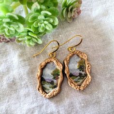 a pair of earrings sitting on top of a table