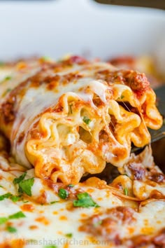 a close up of a slice of pizza being lifted from the casserole dish