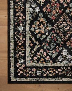 a black area rug with floral designs on it