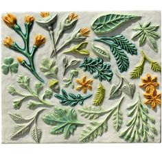 an artisticly designed ceramic tile with flowers and leaves on the side, painted in green and yellow