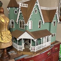 a doll house sitting on top of a wooden dresser