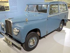 an old blue station wagon is on display