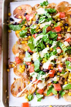 a tray filled with taco salad and tortilla shells