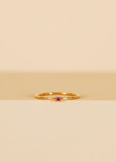 Perfect for making a subtle yet stylish statement. This elegant pinky ring features a dainty, pink cz centerpiece with a sleek band that comfortably hugs the pinky finger, adding a touch of style to any ensemble. Pink Cubic Zirconia18kt gold over brassBand width approx 1 mm Setting approx 2 mmSizes 3,4,5 Matching Pinky Rings, Dainty Pink Sapphire Promise Ring, Pink Ruby Ring In 14k Gold For Promise, Pink Dainty Birthstone Promise Ring, Rose Gold Pink Sapphire Birthstone Promise Ring, Dainty Pink Birthstone Promise Ring, Pink Stackable Birthstone Ring With Round Band, Tiny Pink Promise Ring, Dainty Pink Solitaire Ring