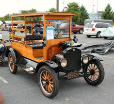 an old fashioned car parked in a parking lot