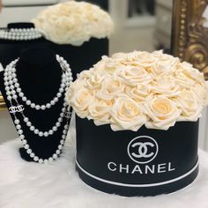 a chanel hat with pearls and roses in it