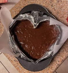 a heart shaped chocolate cake sitting on top of a pan