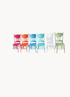 four chairs in different colors and sizes are shown against a white background with no one sitting on the chair