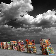 a row of colorfully painted vending machines sitting on top of a sandy beach