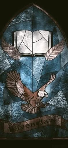 a stained glass window with an eagle and banner