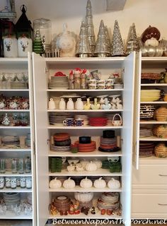 the shelves are filled with dishes and plates