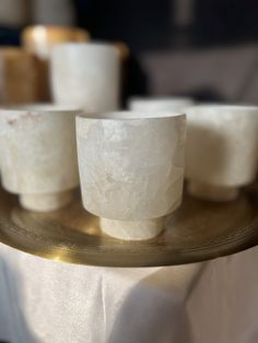 small white cups sitting on top of a metal tray