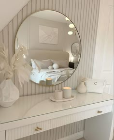 a mirror sitting on top of a white desk