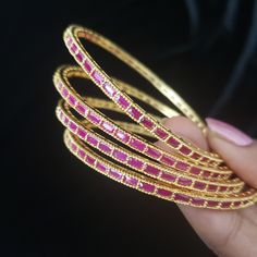 "* Handcrafted Gold Plated 4 Bangle Set. Sold as a set. * Bangles with high quality semi precious ruby stones. * High Quality 22K Gold Plated. Bangles Sizes : 2.4 inches= ( 2.25\" diameter of the inner circle) ; 2.6 inches = ( 2.42\" diameter of the inner circle); 2.8inches = (2.57\" diameter of the inner circle) The gorgeous gold-plated bangles set best exemplifies the careful craftsmanship done on it -- specially picked for you by Nemali Jewelry. It has a special tone of elegance attached to i Elegant Stackable Bangle For Festivals, Gold Bangle With Gemstone For Festivals, Gold Gemstone Bangle For Festivals, Gold Bangle With Stone Setting For Celebration, Gold Bracelet With Stone Setting For Festivals, Gold Bracelets With Stone Setting For Festivals, Adjustable Gemstone Bangle For Wedding, Elegant Stackable Bracelets For Festivals, Gold Bracelet With Stone Setting For Celebration