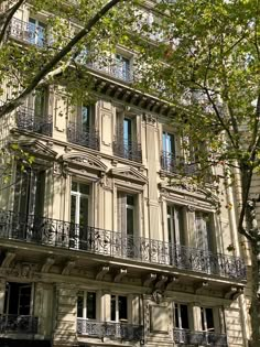 an apartment building with balconies and wrought iron railings in paris, france