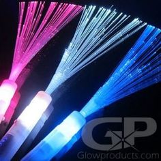 three different colored lights in the dark with white and blue wires attached to each other