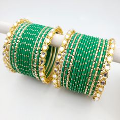 Bangle set comes with 2 sets - 1 per arm. Feel free to mix and match on your own! Step into a world of timeless elegance with our exquisite Kundan gold-plated bangle set, adorned with matte green and accentuated by dazzling gold glitter and gold bangles featuring intricate Kundan work that showcases the intricate beauty of traditional Indian craftsmanship. The bright green adds a vibrant pop to your ensemble, while the gold bangles provide a touch of opulence and sophistication. Love the fusion Luxury Multicolor Formal Bangle, Luxury Green Hand Set Chandbalis, Green Bangle For Party Festivals, Adjustable Green Bangle For Celebration, Green Bangle For Party And Festivals, Adjustable Green Bracelet For Celebration, Adjustable Green Bracelets For Celebration, Festive Green Bangle For Celebration, Festive Green Bracelets For Celebration