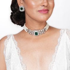 Emerald Choker features stunning green diamonds and CZ stones, complemented by elegant pearls.  Inspired by Indian design, this jewelry set blends classic and modern contemporary styles. Perfect for brides, it makes a thoughtful and luxurious gift for her, adding sophistication and charm to any special occasion. *𝐏𝐑𝐎𝐃𝐔𝐂𝐓 𝐃𝐄𝐓𝐀𝐈𝐋* * 𝐌𝐚𝐭𝐞𝐫𝐢𝐚𝐥: Brass * 𝐏𝐥𝐚𝐭𝐢𝐧𝐠: White Rhodium Plated * 𝐒𝐭𝐨𝐧𝐞: AAA-quality CZ Diamond & Emerald, Pearl. *𝐃𝐈𝐌𝐄𝐍𝐒𝐈𝐎𝐍𝐒* *𝐍𝐞𝐜𝐤𝐥𝐚 Diamond Gemstone Jewelry For Reception, Reception Diamond Gemstone Jewelry, Wedding Diamond Necklace With Jewels In Cubic Zirconia, Wedding Diamond Necklace With Cubic Zirconia, Wedding Cubic Zirconia Diamond Necklace, Wedding Silver Emerald Necklace With Cubic Zirconia, Wedding Silver Emerald Cubic Zirconia Necklace, Hand Set Crystal Emerald Necklace For Wedding, Green Diamond Necklace With Jewels