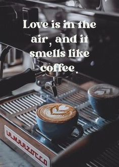 a cup of coffee sitting on top of a counter next to an espresso machine