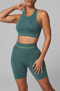 Introducing LiCi's True Form collection, a seamless activewear line that serves as a reminder to be true to yourself. Crafted with a fabric that feels silky smooth to the touch, and enhanced with a full interlocking knit construction, this collection offers the perfect combination of compression and breathability. High-Waisted No Front Seam Back Scrunch Seam Detail to Enhance Curves Ribbed Band Detail for Extra Support 6" Inseam LiCi Logo placement center top back Fabric: Seamless 90% Nylon 10% Versatile Green Seamless Activewear, Versatile Seamless Nylon Activewear, Seamless Nylon Yoga Activewear, Seamless Nylon Activewear For Yoga, Green Stretch Sports Bra In Elastane, Green Stretch Sports Bra Made Of Elastane, Micro-elastic Seamless Green Activewear, Green Micro-elastic Seamless Activewear, Green High Stretch Seamless Activewear