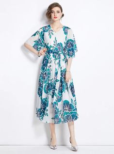 Breezes through every occasion with elegance, this floral midi dress is crafted for the modern woman who values both style and comfort. The light blue and navy floral patterns pop against the white background, creating a refreshing visual appeal. This dress features a loose fit, ensuring it drapes gracefully over any body type, while the mid-length and wide sleeves provide coverage yet maintain a breezy feel. Ideal for brunches, office wear, or weekend outings, it’s versatile enough for various Blue A-line Floral Dress For The Beach, Light Blue A-line Midi Dress With Floral Print, Light Blue Floral Dress For Summer, Chic Blue Printed Floral Dress, Blue Floral Print Dress For Summer, Blue Floral Print Summer Dress, White Printed Floral Dress With Short Sleeves, White Floral Print V-neck Midi Dress, White Floral Printed Knee-length Dress