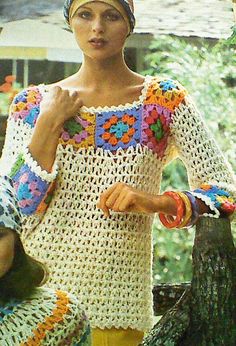 a woman wearing a crochet top and holding an umbrella