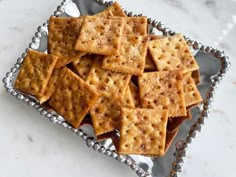 some crackers are sitting on a silver tray