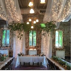 an indoor dining room with lights strung from the ceiling