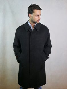 This 1990s German vintage black Loden wool coat has a wing collar and closes in the front with four concealed buttons (and there is a leather button at the neckline if you want to close the coat fully). The handsome overcoat has two pockets on the front, and the back features a yoke and long inverted pleat. Size: Extra Large Material: 95% Tiroler Loden Wool, 5% Polyamide Condition: Excellent (Professionally Cleaned ... soft and supple, with no stains, tears, wear spots, or weaknesses in the seam Mens Wool Coats, Wing Collar, A Wing, Wool Coat, Hungary, Vintage Black, Extra Large, Vintage Outfits, Mens Jackets