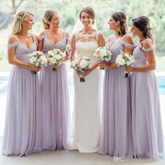 the bride and her bridesmaids are all wearing lavender colored dresses