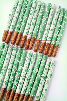 green and white paper straws with sprinkles are arranged on a table