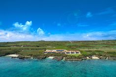 an aerial view of the resort and its surrounding grounds from above, looking down on the ocean