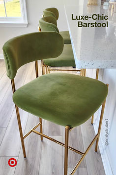 three green velvet bar stools with gold legs and back rests against a white countertop