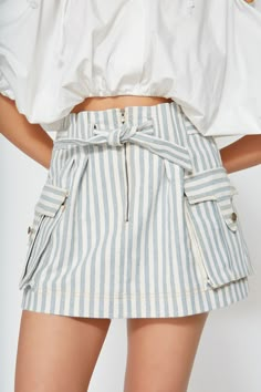 Equally chic and versatile, our denim skirt is woven from upcycled cotton into a vintage blue and white stripe without the use of toxic chemicals. Designed to sit high on your waist with a paperbag look, this style fastens with a center-front zip and a built-in belt to cinch the waist as desired. This mini skirt has an A-line cut with functional cargo pockets. Pair with sandals, white sneakers and booties for picnic-perfect days, beach walks or road trips. It’s an everyday staple. This item is m Skort Outfit, Perfect Days, Denim Skort, Beach Walks, A Line Cut, Vintage Blue And White, Sandals White, Toxic Chemicals, Summer Solstice