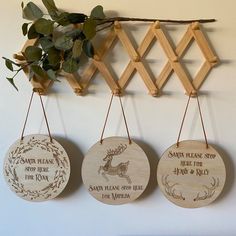 three wooden ornaments hanging on a wall