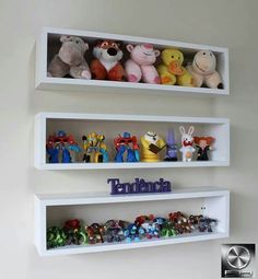 three white shelves filled with toy cars on top of each other