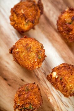 several fried food items on a wooden cutting board