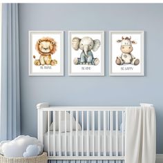 a baby's nursery room with three pictures on the wall and a crib