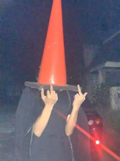 a man with a red cone on his head