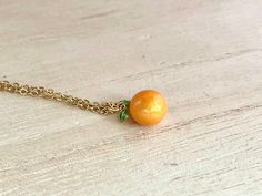 This dainty orange / tangerine necklace is made of the following: (1) Gold plated orange slice charm (charm size: 12 x 8.5mm) (2) Gold plated or 14KGF chain and findings ✏️ Please choose the length of the chain (the length includes clasp and findings) ✏️ Please choose your desired plating of chain ❣️ If you are unsure about which length to choose , please leave me a note to request an extension chain to be added to the chain at check out. 🍊EARRINGS 🍊 Threader -> https://www.etsy.com/listing Orange Round Necklace For Gifts, Orange Pendant Charm Necklaces For Gifts, Orange Necklace With Adjustable Chain For Gift, Orange Necklace With Adjustable Chain As Gift, Adjustable Peach Jewelry For Gifts, Adjustable Round Orange Necklace, Orange Dainty Jewelry For Gifts, Peach Necklace Gift, Dainty Orange Jewelry For Gifts