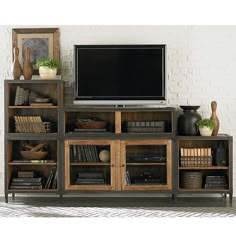 an entertainment center with bookshelves and a flat screen tv