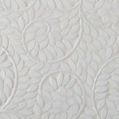 white wallpaper with an intricate design in the center and leaves on the back side