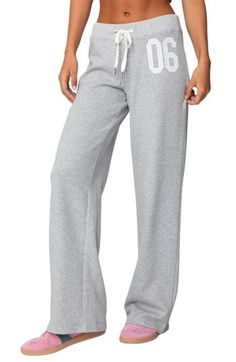 Sporty numbering at the thigh lends ultracool athletic style to these cozy cotton-blend sweatpants made with trendy wide legs. Elastic/drawstring waist 50% cotton, 50% polyester Machine wash, dry flat Imported Sporty Cotton Pants For Leisure, Sporty Cotton Bottoms For Loungewear, Cotton Athleisure Sweats For Sports Season, Cotton Joggers With Drawstring, Sporty Cotton Long Pants, Full-length Drawstring Sweatpants For Sports, Full Length Drawstring Sweatpants For Sports, Cotton Sportswear Bottoms For Leisure, Sporty Cotton Joggers For Leisure